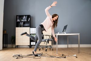 An office accident claim could be made for tripping over tangled cables on the floor. 