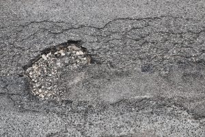 A pothole in the road. 