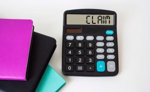 A calculator with the word 'claim' on its screen.