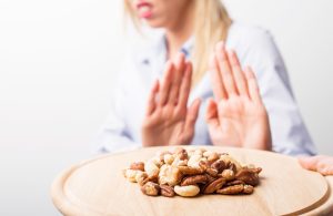 A woman with a food allergy refuses to eat nuts