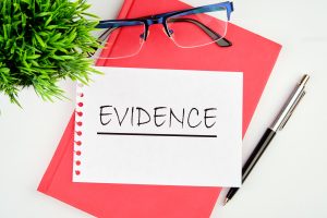 An evidence notebook and glasses to support a cold injury compensation claim. 